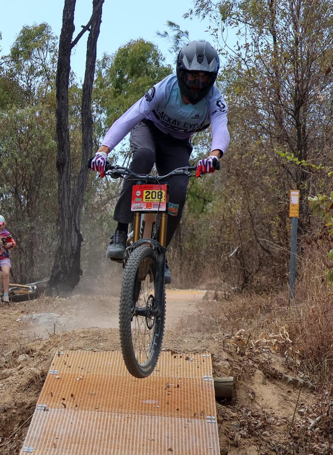 Mackay Cycles rider number 208 jumping on a mountain bike downhill trail in Townsville