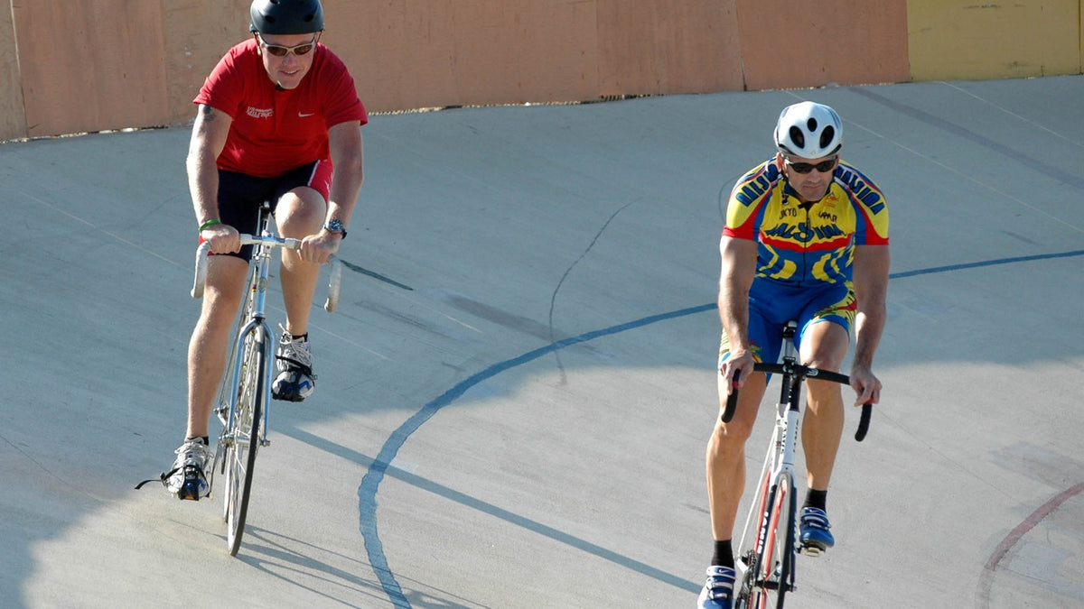 Track cyclists riding the velodrome banking